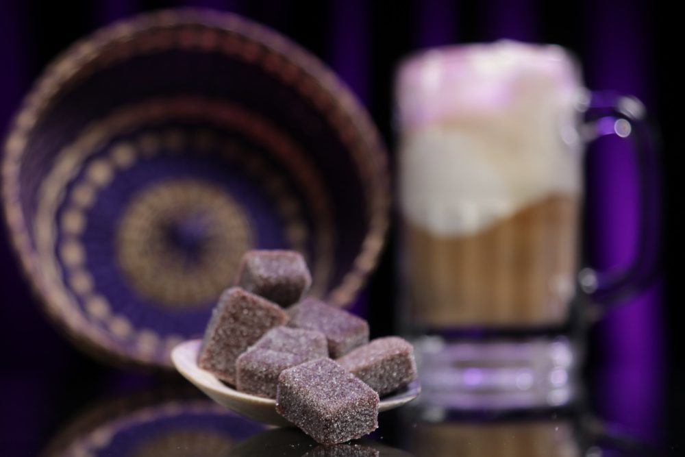 These delicious mouthwatering gummies are in the foreground while a blurred out rootbeer float is in the background.