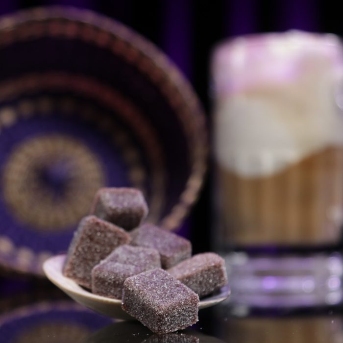 These delicious mouthwatering gummies are in the foreground while a blurred out rootbeer float is in the background.