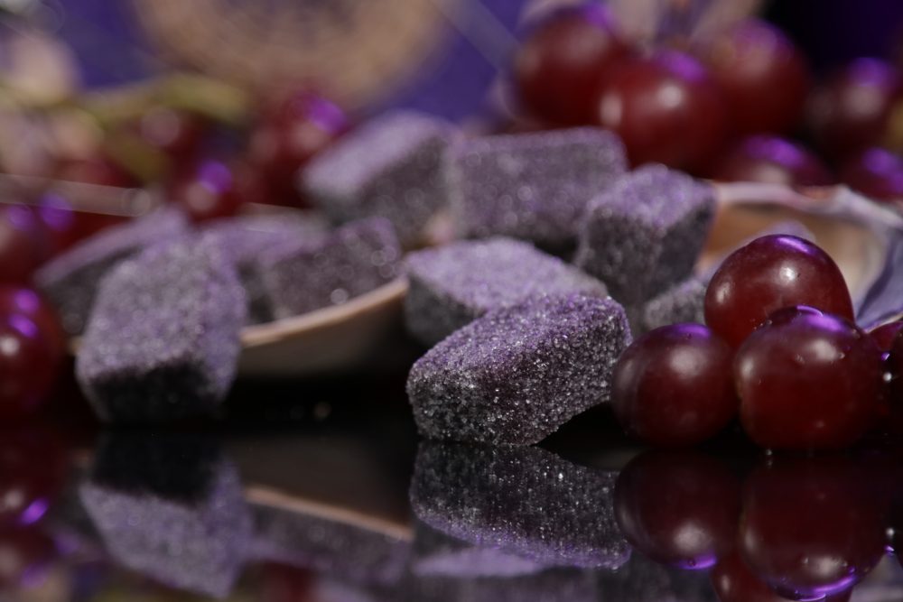 These grape gummies are nestled within real grapes.